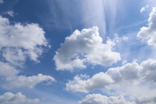 Beautiful fluffy white cloud formations in a deep blue summer sky