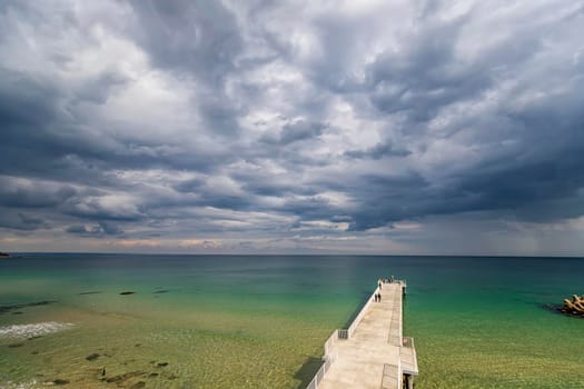 Landscape to concrete pier. Scenic view from shore