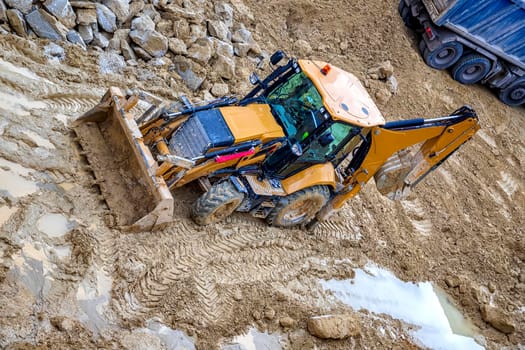 Yellow bulldozer in loam soil at Industrial construction site 