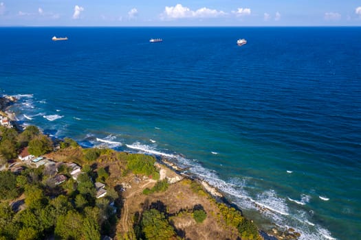 A beautiful aerial view from drone to the coastline and ships near horizon