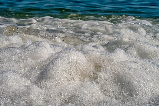 Front view of sea waves splash with foam. Close up