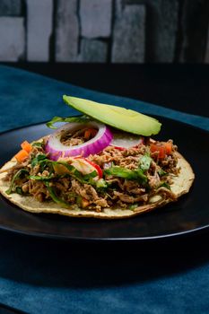 Beef salpicon on corn tostadas. Mexican spicy beef steak salad with carrot, olives, chili, onion, lettuce and radish. Delicious Mexican cuisine