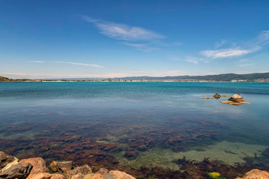 clear weather summer daytime scenic view of sea bay and rocky shore line 