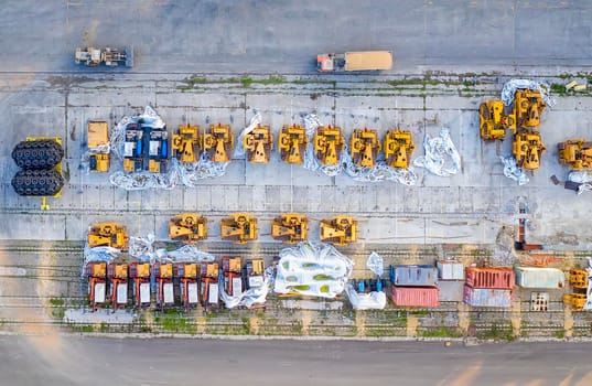 Aerial top view from drone of industrial equipment on port parking. Top view