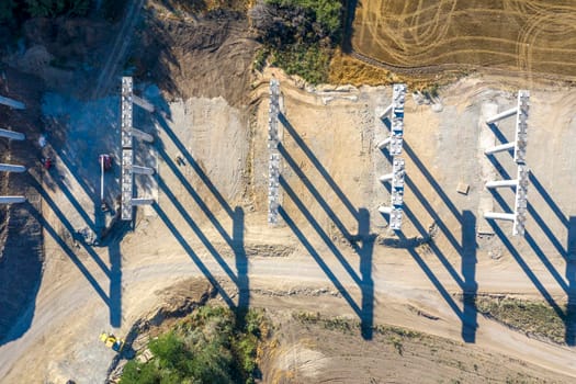 Abstract view with shadows of concrete new bridge supports. Construction of a road bridge. Top view