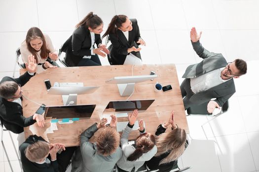 top view. business team applauding at a work meeting . the concept of successful work