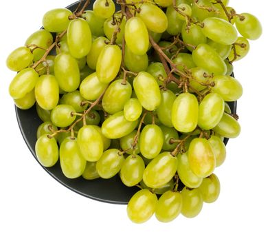 A bunch of table grapes in a plate, on a white background isolated
