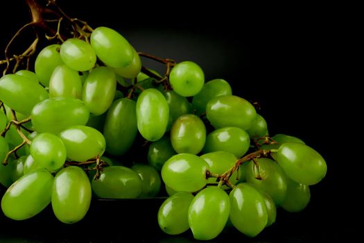 A bunch of table grapes, on a black background