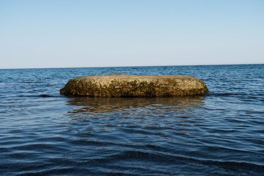 Stone in the sea, stone is washed from all sides, by sea water