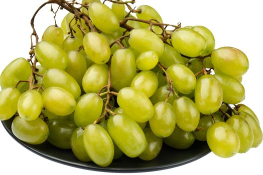 A bunch of table grapes in a plate, on a white background isolated