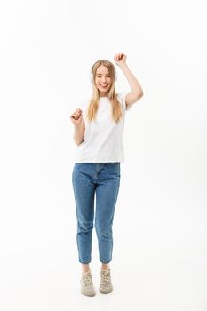 Lifestyle Concept: Portrait of a cheerful happy girl student listening to music with headphones while dancing isolated over white background.