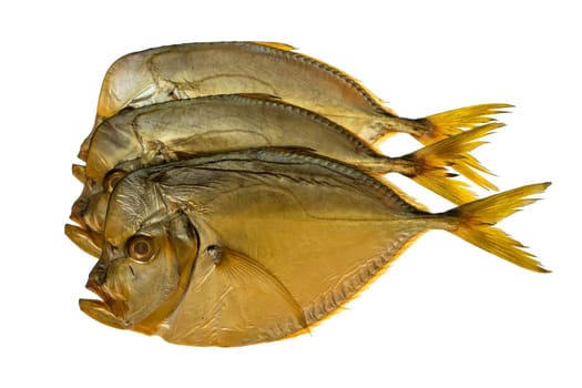 Three smoked vomer fish, on a white plate isolated