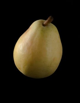 One ripe, juicy pear on a black background