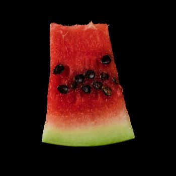 Piece of ripe watermelon, on black background, isolated