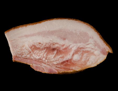 A thick piece of ready-made appetizing, smoked, lard with layers of meat, on a black background in isolation