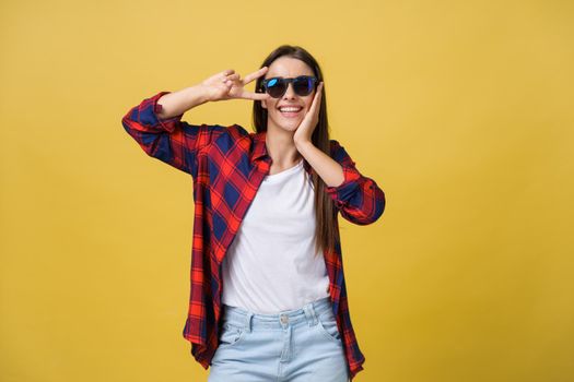 Open mouth people entertainment concept. Close up portrait of playful excited funny joyful positive optimistic with toothy smile girl showing v-sign isolated on yellow background copy space.