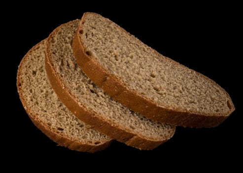 Three slices of dark bread, on a black background in isolation