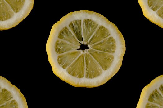 Five lemon slices lined up in a semicircle on a black background