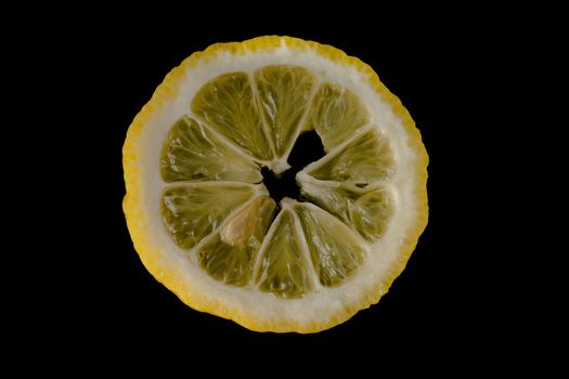 Five lemon slices lined up in a semicircle on a black background