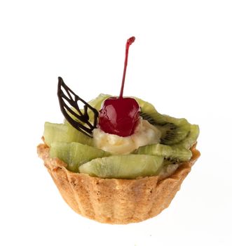 Dessert, cake with kiwi and cherries on a white plate isolated