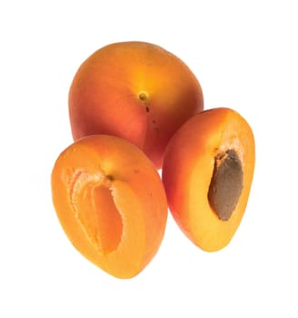 Ripe apricot fruits, one whole and two halves, on a white background