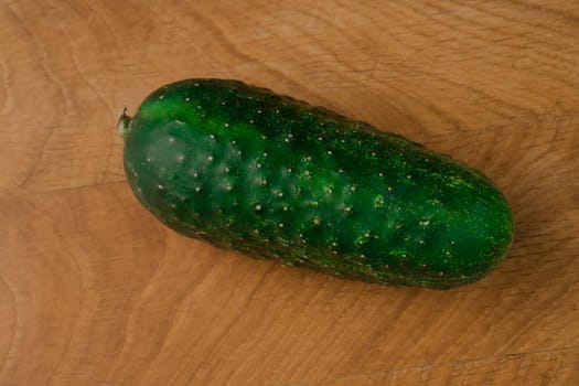 close-up shot of fresh green cucumber on a wooden board