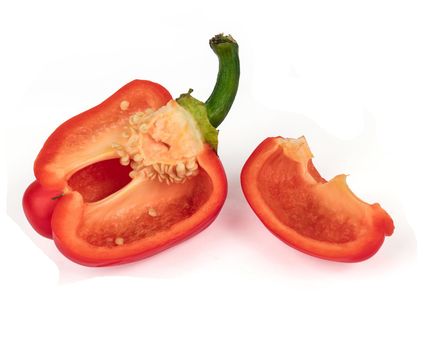 Ripe sweet red peppers, cut into pieces, on a white background, with a shadow