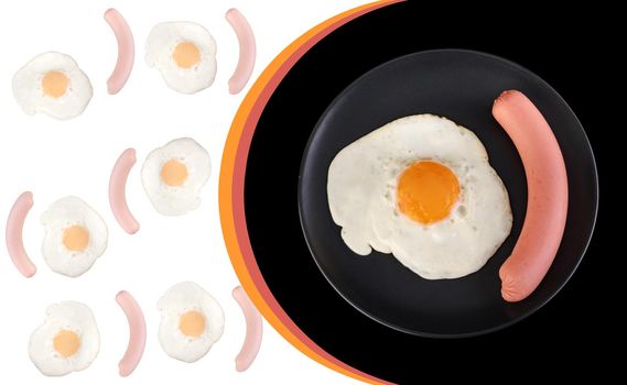 Fried egg and sausage on a black plate, on a black background, place under the text on a white background