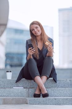 young woman makes an online order on her smartphone. people and technology