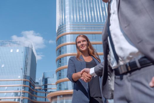 young woman shaking hands with her business partner. photo with copy space