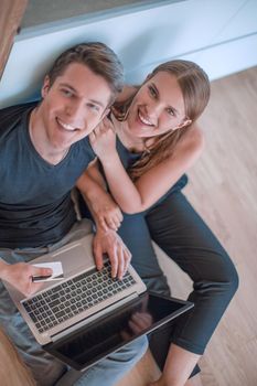 young family uses a credit card in their new apartment . people and technology