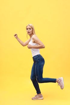 Full length size studio photo portrait of beautiful charming good mood toothy beaming smile tender careless carefree cheerful gorgeous lady isolated pastel yellow background.