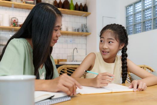 Homeschool Asian mother and little young girl student learning online class. E-learning Online Education concept