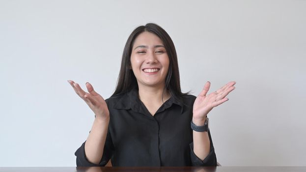Smiling asian woman making video conference, online distant job interview.