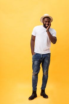 Full length young handsome african american man looking away.