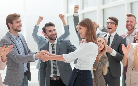 happy employees congratulating their leader. success concept