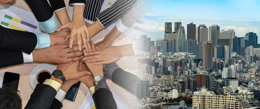 Happy business people celebrate teamwork success together with joy at office table shot from top view . Young businessman and businesswoman workers express cheerful victory in broaden view .