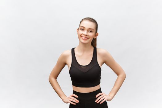 Image of a beautiful strong happy cheerful young sports woman posing isolated on grey background