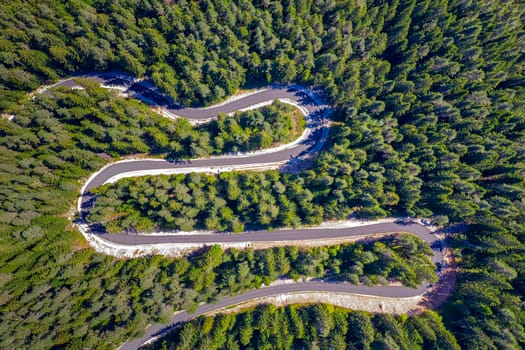 Aerial view from drone of curves of mountain road. Transportation and infrastructure concept