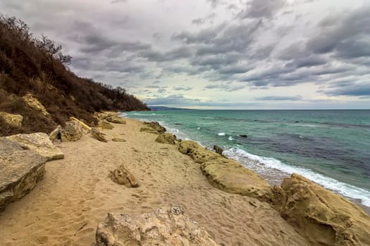 scenic view at a stony beach with cloudy sky