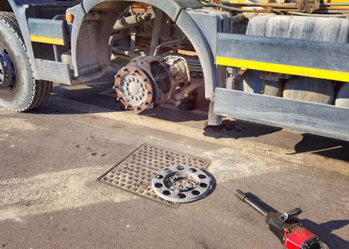 Changing wheel on truck with pneumatic wrench