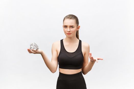 Portrait of an upset sad woman holding measuring tape looking at camera isolated over white background.