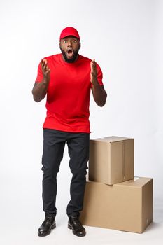Delivery Concept: Handsome african delivery man shocking facial expression. Isolated over grey background