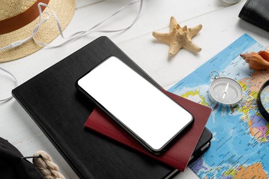 travel plan, trip and vacation, technology. Hign angle view of a smartphone with white screen for mockup, travel and tourism. Copy space