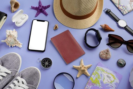 travel plan, trip and vacation, technology. Top view travel accessories with shoes, map, smartphone with mockup screen, hat on very peri purple background