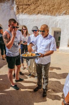HAMMAMET, TUNISIA - Oct 2014: Man is feeding with cake and honey on October 7, 2014 in Hammamet, Tunisia