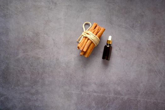 dropping cinnamon essential oil in a container