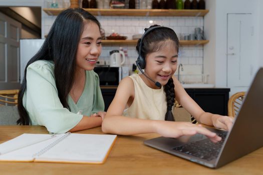 Homeschool Asian mother and little young girl student learning online class. E-learning Online Education concept