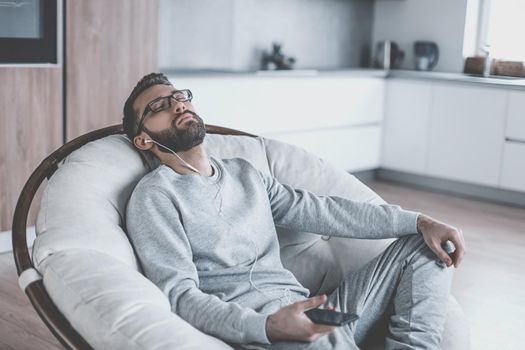 close up. man enjoying his favorite music,sitting in a chair