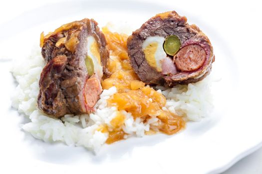 beef roulade filled with egg, sausage, bacon and prickle served with rice